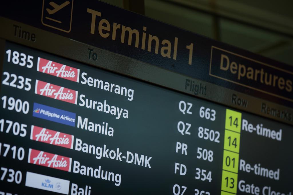 SINGAPORE - DECEMBER 28: An electronic flight information departure board showing information for AirAsia flights departing for Surabaya is seen at Changi Airport on December 28, 2014 in Singapore. AirAsia announced that flight QZ8501 from Surabaya, Indonesia to Singapore lost contact with air traffic control on the morning of December 28. (Photo by Suhaimi Abdullah/Getty Images)