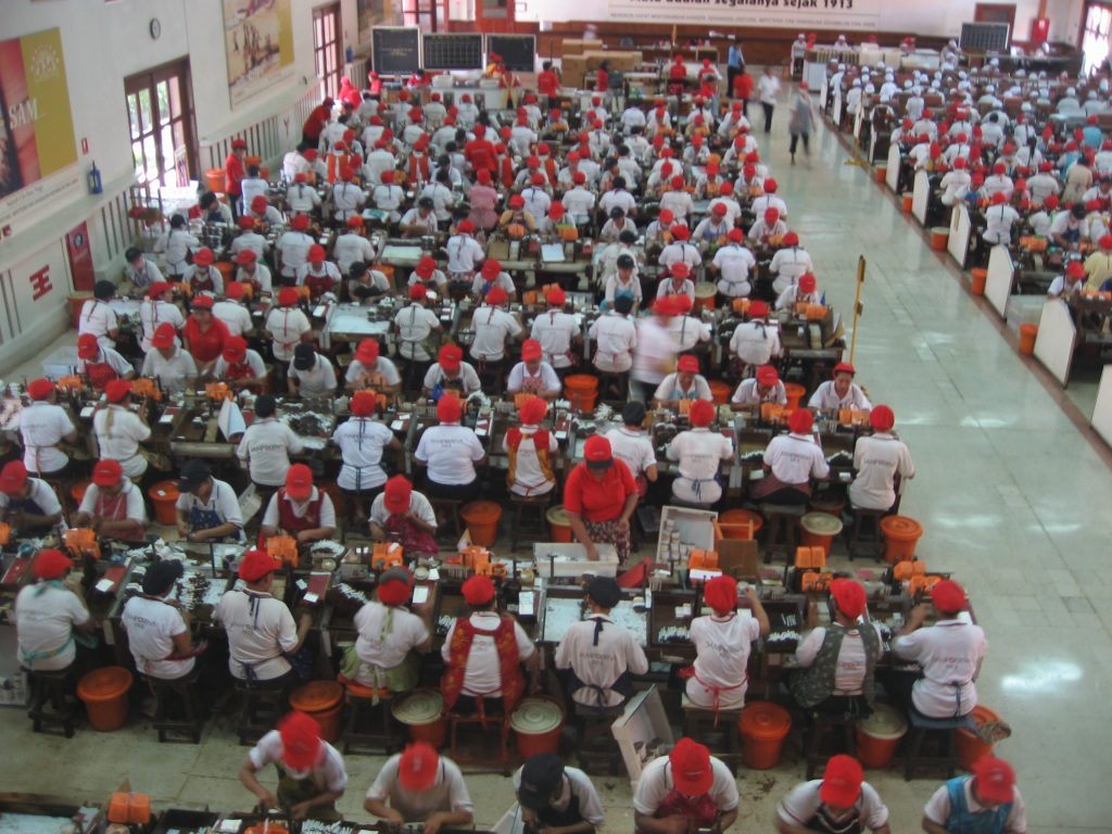 Workers are rolling and packing cigarettes at the House of Sampoerna