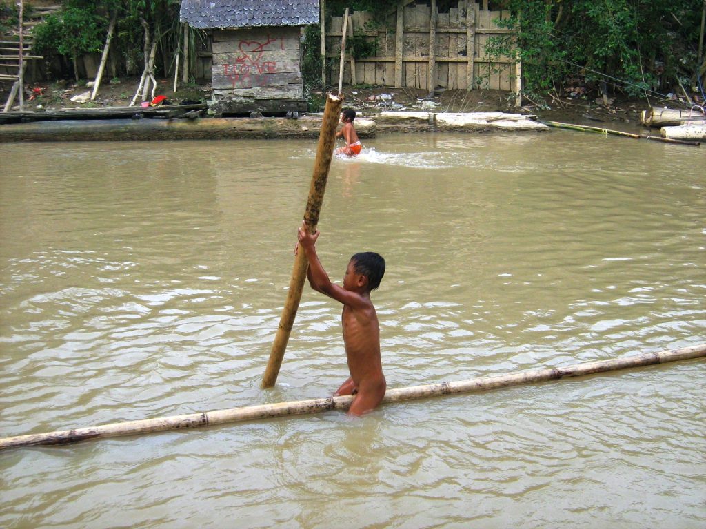 A Dayak boy practicing early lessons of life