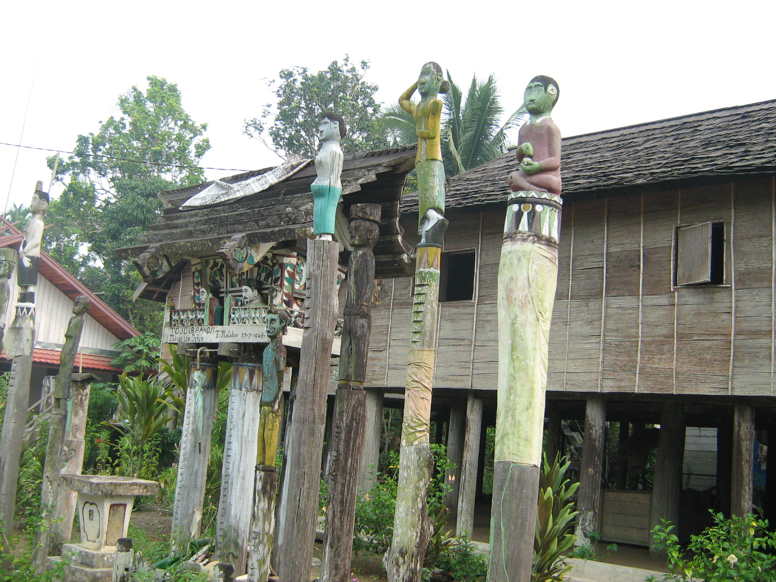 Gods are hoisted on poles in front of Betang