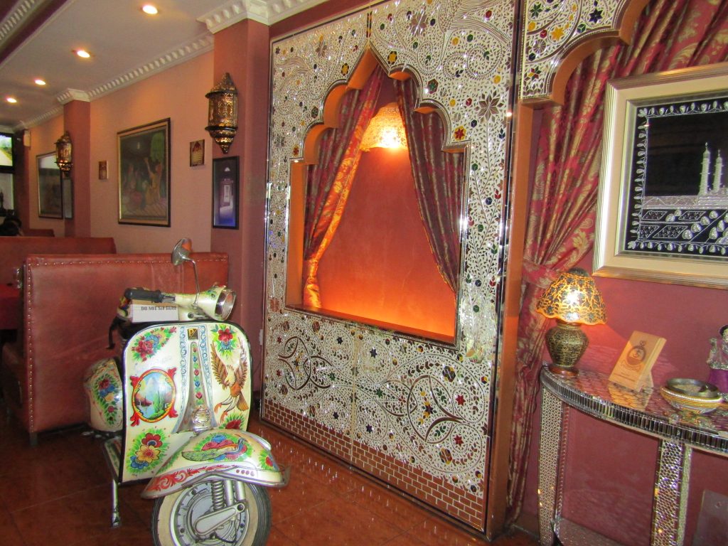 A funky corner inside Koh-e-noor Restaurant, with the unique painted Vespa