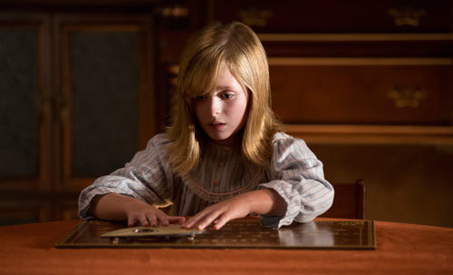 Doris plays the Ouija board to contact her deceased father