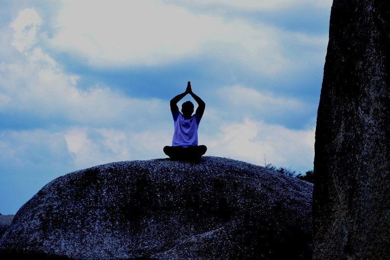 Meditating atop a huge granitic boulder