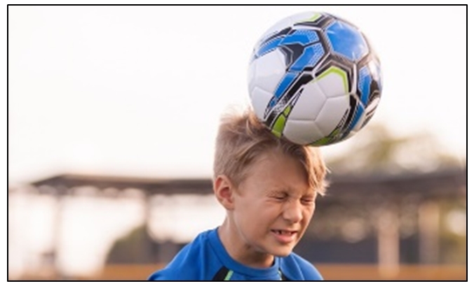 hildren heading ball while playing football