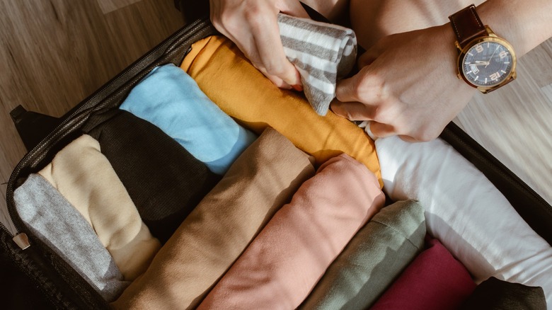 roll up your clothes for efficient packing