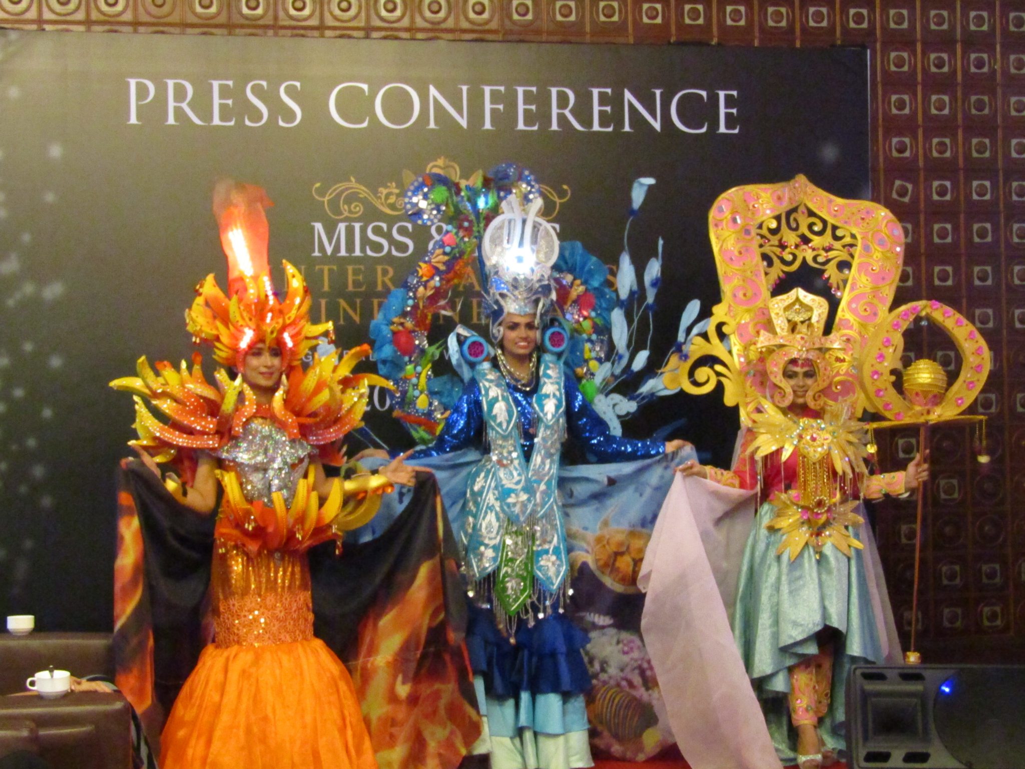 The 3 contestants in costumes by designer Nabil Cartyn Carnival