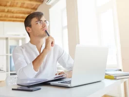 A Man is Thinking in Front of Laptop