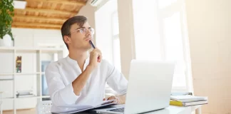 A Man is Thinking in Front of Laptop