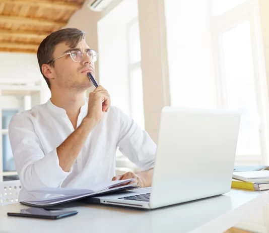 A Man is Thinking in Front of Laptop