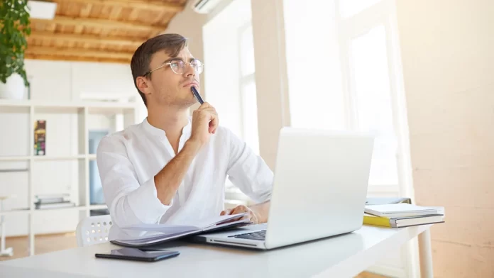 A Man is Thinking in Front of Laptop