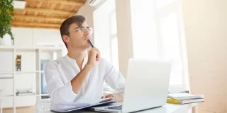 A Man is Thinking in Front of Laptop