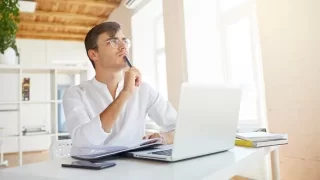 A Man is Thinking in Front of Laptop