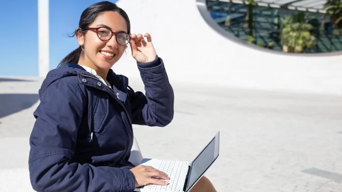 Cheerful young woman eyeglasses using laptop and tips to be smarter