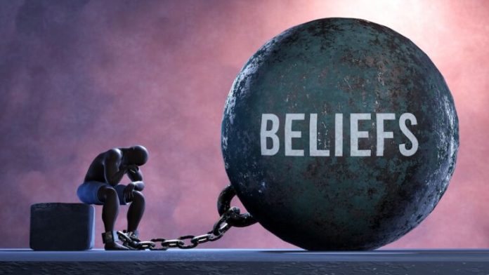Beliefs - a gigantic and unmovable weight chained to a vulnerable and suffering person in pain, misery and helplessness. Cold and tragic condition created by Beliefs Limiting Beliefs Are Lies We Accept